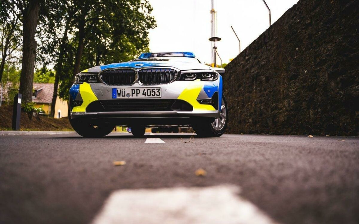 Polizei im Einsatz Polizeiauto Blaulicht Straßenrand im Vordergrund eine Straßenmarkierung Polizei im Einsatz Polizeiauto Blaulicht Straßenrand im Vordergrund eine Straßenmarkierung